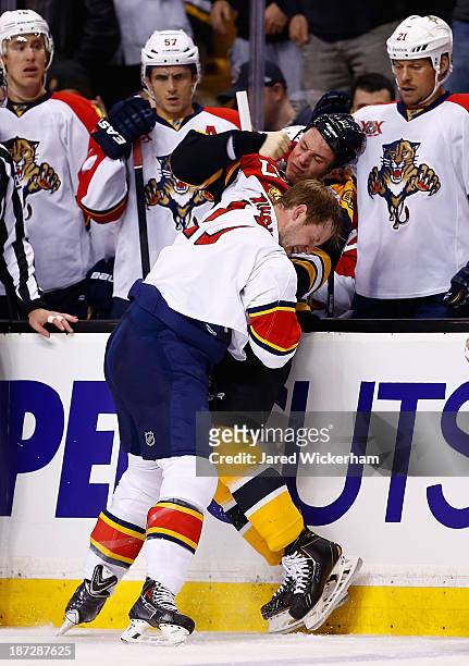 Gregory Campbell of the Boston Bruins fights Jesse Winchester of the Florida Panthers in the first period at TD Garden on November 7, 2013 in Boston,...