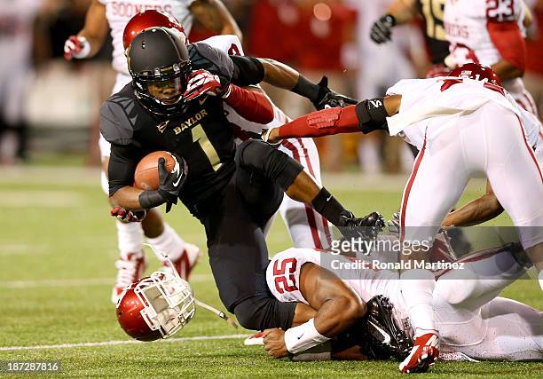 Kick returner Corey Coleman of the Baylor Bears is tackled on the opening kick in the first quarter against the Oklahoma Sooners at Floyd Casey...
