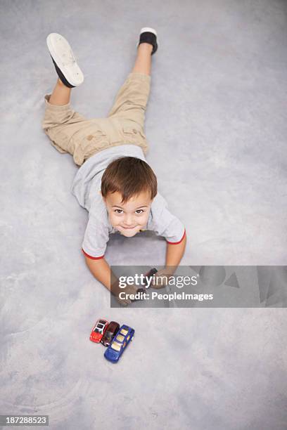 playing in the garage - boy playing with cars stock pictures, royalty-free photos & images