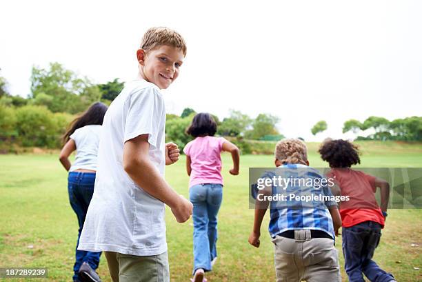 enjoying break time - boy running back stock pictures, royalty-free photos & images