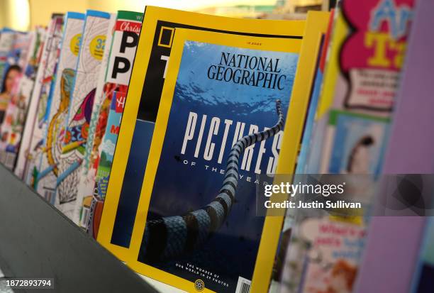 Copies of the December issue of National Geographic magazine are displayed on a shelf at Smoke Signals Newsstand on December 21, 2023 in San...