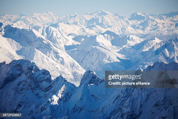 December 2023, Bavaria, Grainau: The mountain panorama as seen from the summit of the Zugspitze. On the left you can see the icy summit of the...