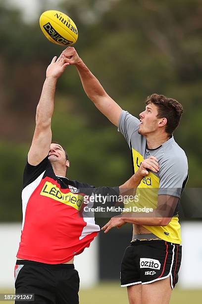 Assistant coach Aaron Hamill and Tom Hickey contest for the ball during a St Kilda Saints AFL training session on November 8, 2013 in Melbourne,...
