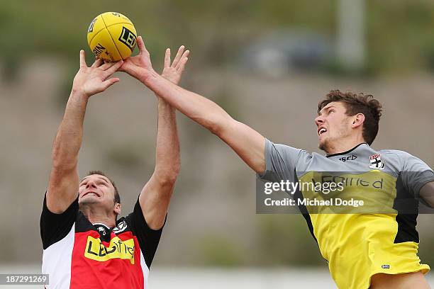 Assistant coach Aaron Hamill and Tom Hickey contest for the ball during a St Kilda Saints AFL training session on November 8, 2013 in Melbourne,...