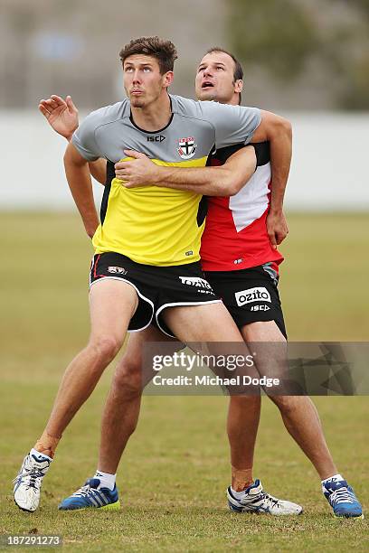 Assistant coach Aaron Hamill and Tom Hickey contest for the ball during a St Kilda Saints AFL training session on November 8, 2013 in Melbourne,...