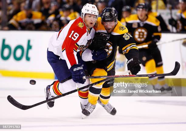 Shawn Matthias of the Florida Panthers battles for the puck against Johnny Boychuk of the Boston Bruins in the second period at TD Garden on November...