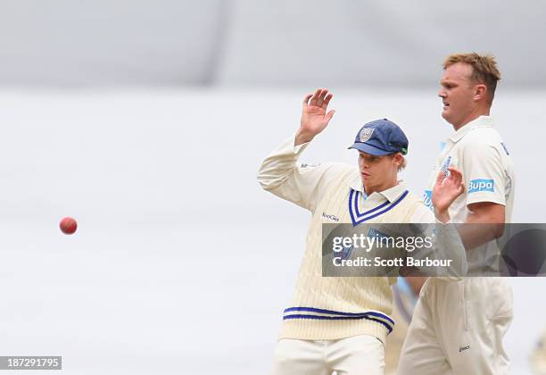 Steven Smith and Doug Bollinger of the Blues avoid a ball thrown at the stumps during day three of the Sheffield Shield match between the Victoria...