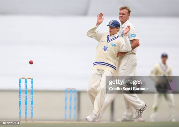 Steven Smith and Doug Bollinger of the Blues avoid a ball thrown at the stumps during day three of the Sheffield Shield match between the Victoria...