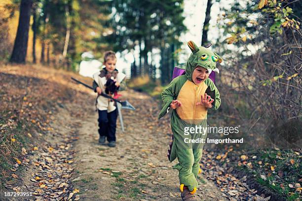 dragon chased by a fearsome knight - child playing dress up bildbanksfoton och bilder