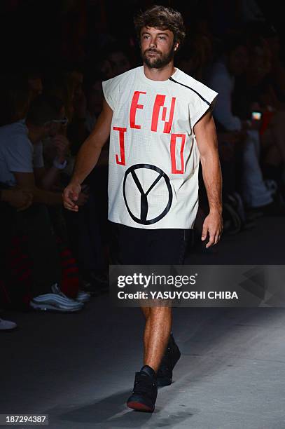 Brazilian actor Kayky Brito presents a creation by Coca-Cola Jeans during the 2014 Winter collection of Fashion Rio in Rio de Janeiro, Brazil, on...