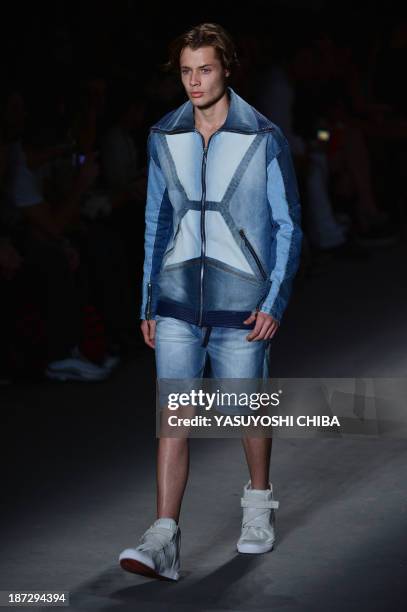 Model presents a creation by Coca-Cola Jeans during the 2014 Winter collection of Fashion Rio in Rio de Janeiro, Brazil, on November 7, 2013. AFP...