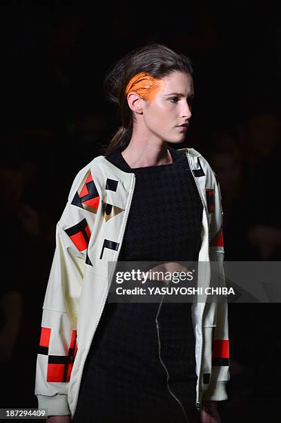 Model presents a creation by Coca-Cola Jeans during the 2014 Winter collection of Fashion Rio in Rio de Janeiro, Brazil, on November 7, 2013. AFP...