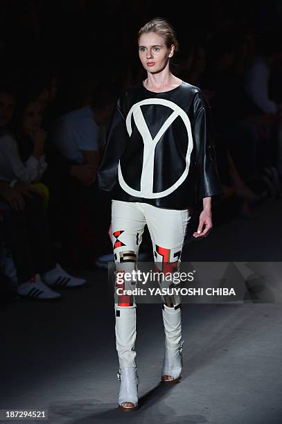 Model presents a creation by Coca-Cola Jeans during the 2014 Winter collection of Fashion Rio in Rio de Janeiro, Brazil, on November 7, 2013. AFP...