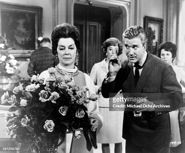 Actress Rosalind Russell and actor Leslie Nielsen on set of the Universal Studios movie "Rosie!" in 1967.