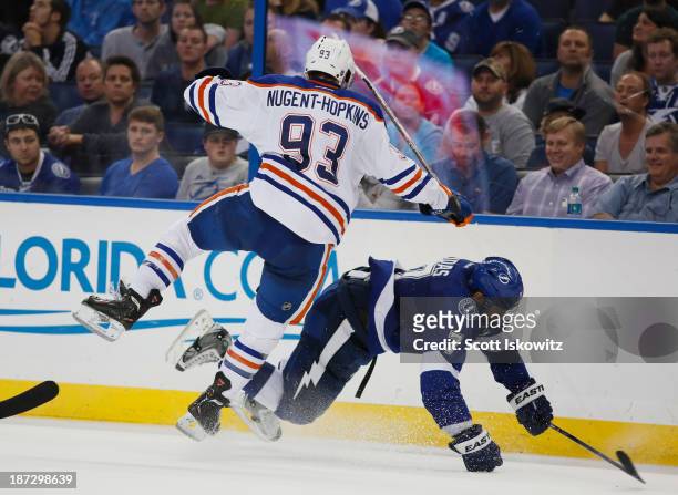 Fl. Ryan Nugent-Hopkins of the Edmonton Oilers collides with Radko Gudas of the Tampa Bay Lightning during the third period as they battle for the...
