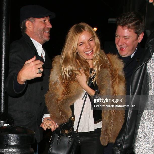 Sean Pertwee and Sienna Miller leaving the Groucho club on November 7, 2013 in London, England.