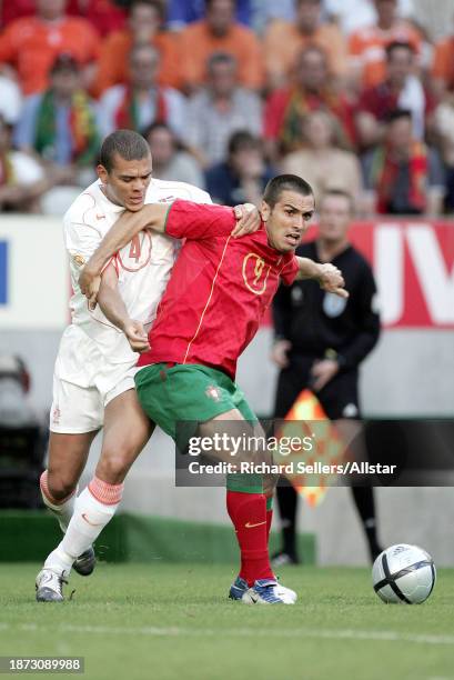 June 30: Wilfred Bouma of Netherlands and Pauleta of Portugal challenge during the UEFA Euro 2004 Semi Final match between Portugal and Netherlands...