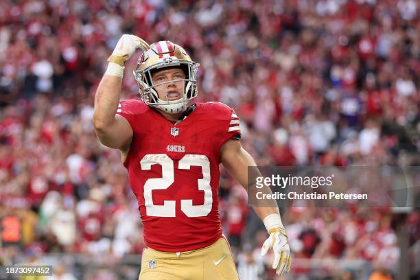 Running back Christian McCaffrey of the San Francisco 49ers celebrates after scoring a 5-yard rushing touchdown against the Arizona Cardinals during...