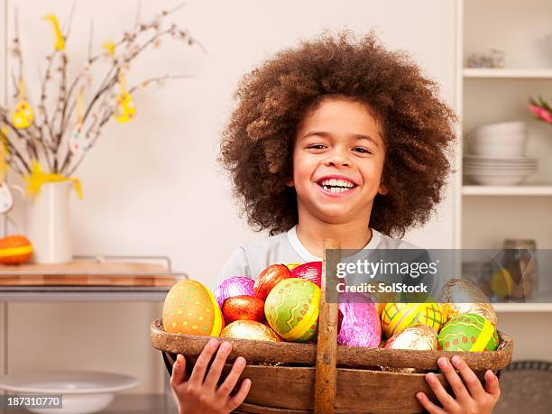 little boy with easter eggs in basket - african easter stock pictures, royalty-free photos & images