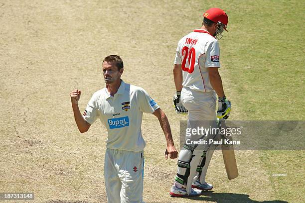 Michael Hogan of the Warriors celebrates the wicket of Kelvin Smith of the Redbacks during day three of the Sheffield Shield match between the...