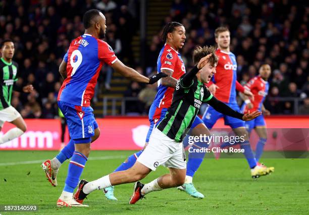 Jack Hinshelwood of Brighton & Hove Albion goes down under a challenge from Jordan Ayew of Crystal Palace but is not awarded a penalty kick during...