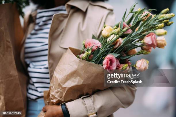 unrecognizable shopper with groceries and flowers - fall bouquet stock pictures, royalty-free photos & images