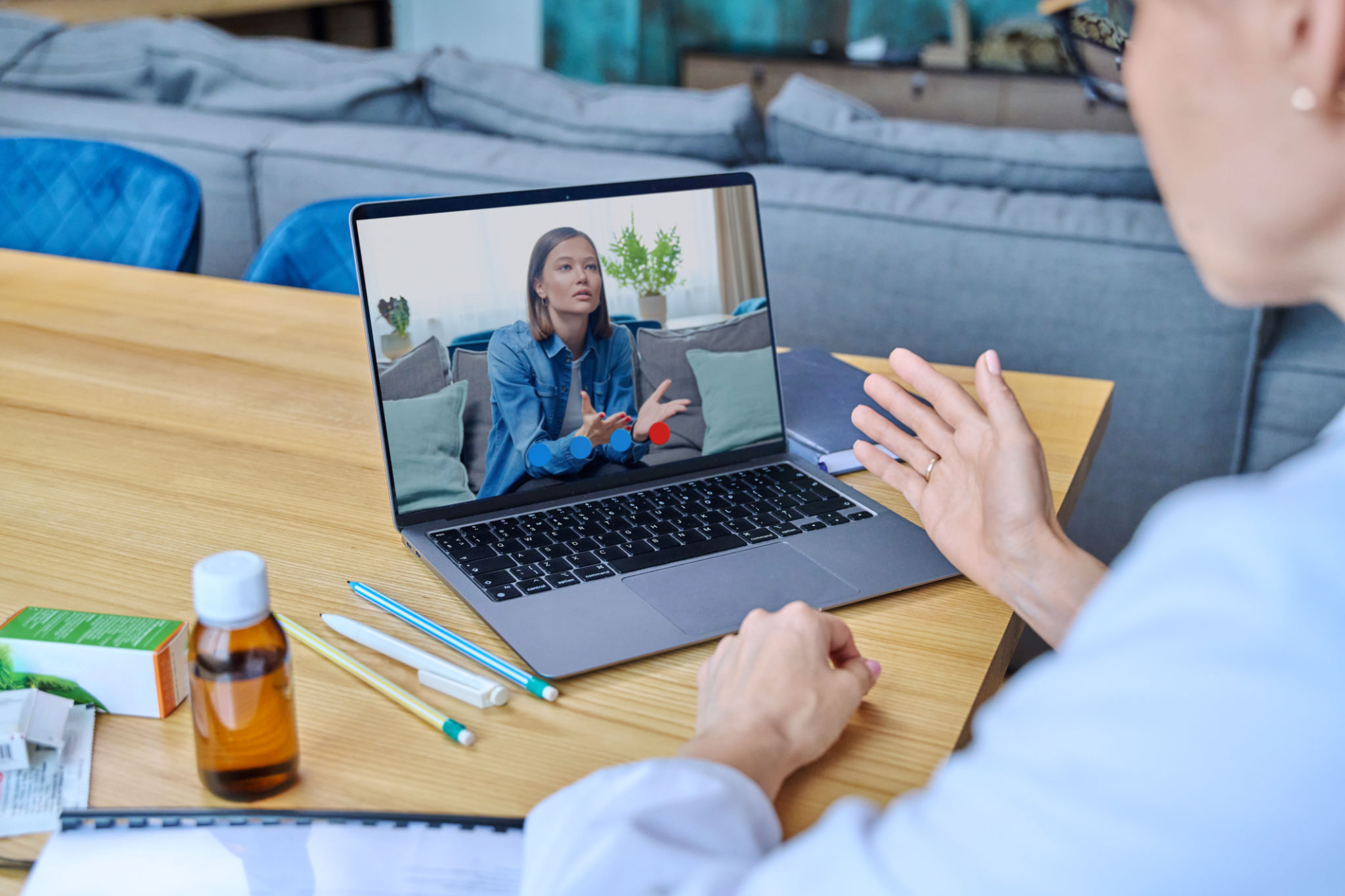 Young woman in laptop screen having video online counseling with female doctor Young woman in laptop screen having video online counseling with female doctor