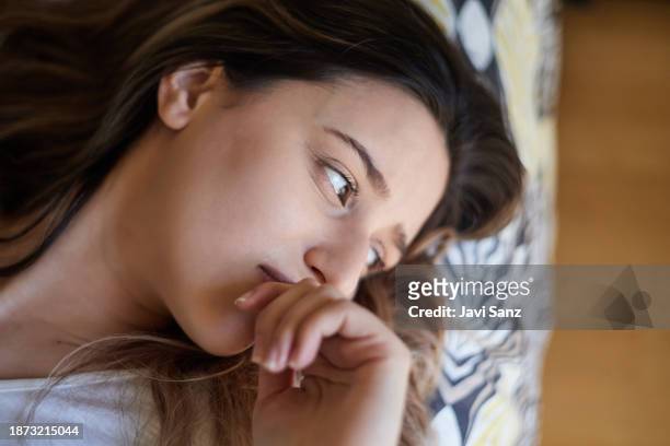 close-up of a sad young woman crying with depression at home. mental health concept. - photos of suicide victims stock pictures, royalty-free photos & images