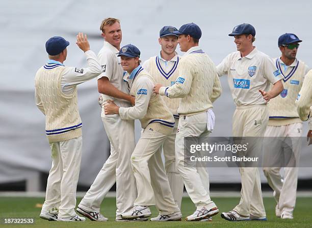Doug Bollinger of the Blues is congratulated by his teammates after dismissing Rob Quiney of the Bushrangers during day three of the Sheffield Shield...