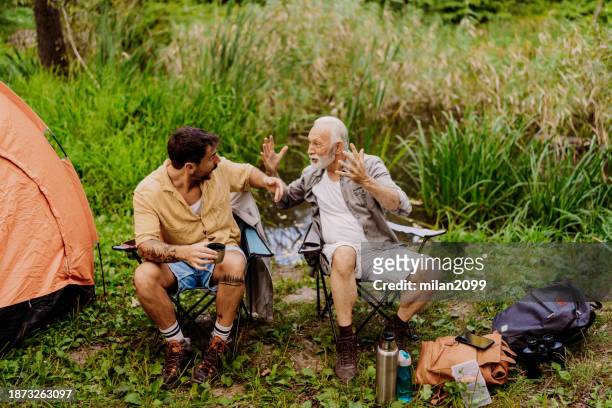 father and son camping - milan2099 stock pictures, royalty-free photos & images