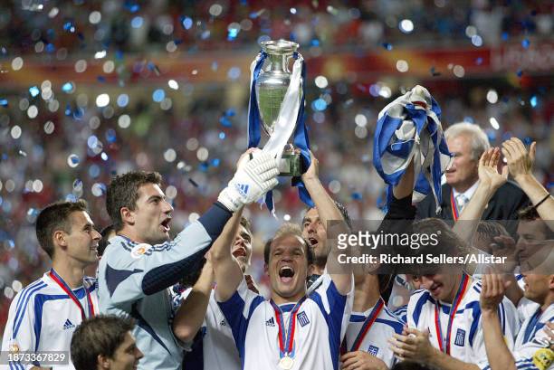 July 4: Kostas Chalkias and Angelis Basinas of Greece, lifts the European Championship Trophy after winning the UEFA Euro 2004 Final match between...