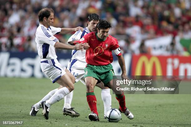 July 4: Zisis Vryzas and Angelos Basinas of Greece challenge Luis Figo of Portugal during the UEFA Euro 2004 Final match between Portugal and Greece...