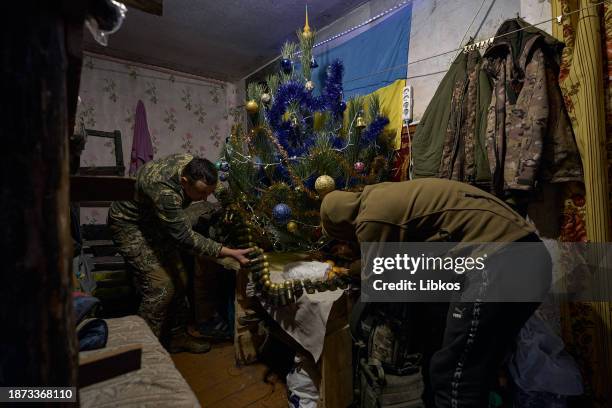 One of the soldiers brings a ribbon from an MK-19 grenade launcher as a Christmas tree decoration. The division commander with the call sign "Kalyna"...