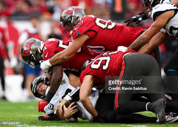 Lavonte David of the Tampa Bay Buccaneers sacks Trevor Lawrence of the Jacksonville Jaguars during the second quarter of an NFL football game at...