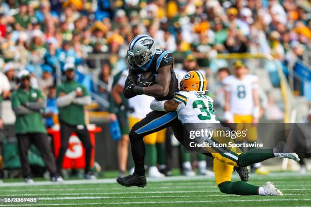 Jonathan Owens of the Green Bay Packers tackles Stephen Sullivan of the Carolina Panthers during an NFL game at Bank of America Stadium on December...