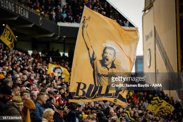Wolverhampton Wanderers fans hold up a banner with an image of their former player Steve Bull on during the Premier League match between...
