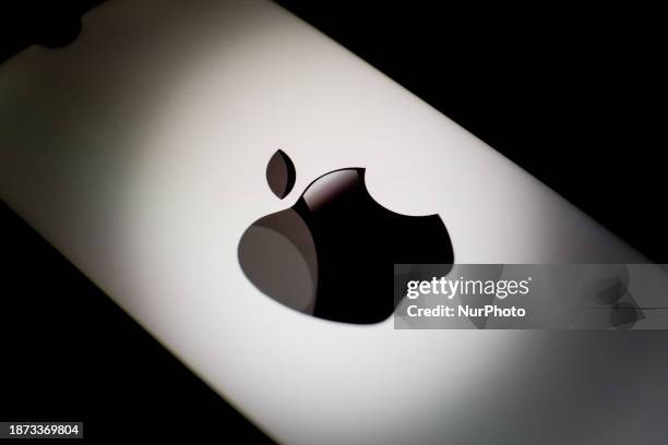 The Apple logo is being displayed on a smartphone screen in Athens, Greece, on December 24, 2023.