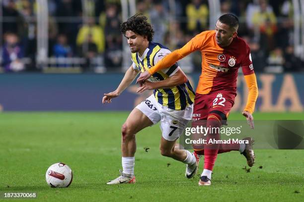 Hakim Ziyech of Galatasaray is challenged by Ferdi Kadioglu of Fenerbahce during the Turkish Super League match between Fenerbahce and Galatasaray at...