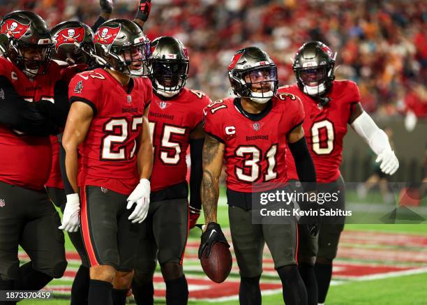 Antoine Winfield Jr. #31 of the Tampa Bay Buccaneers celebrates with teammates after recovering a fumble during the fourth quarter of an NFL football...