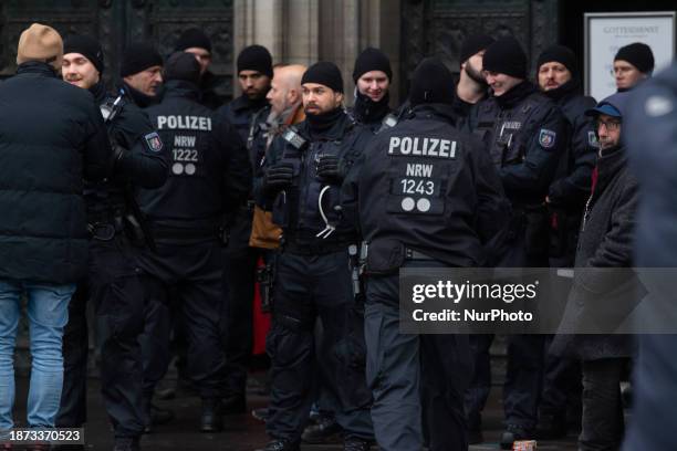 Police are seen at the entrance of Cologne Cathedral, restricting tourists from entering in Cologne, Germany, on December 24 amid a possible terror...