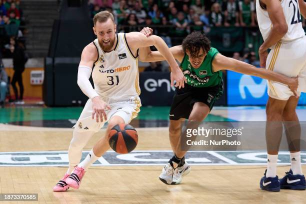 Dzanan Musa of Real Madrid is in action with Yannick Kraag of Joventut Badalona during the ACB Liga Endesa match at Pabellon Olimpico de Badalona in...