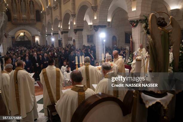 Latin Patriarch of Jerusalem Pierbattista Pizzaballa leads the Christmas midnight Mass at the Church of the Nativity compound in the biblical city of...