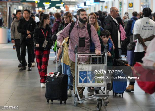 Travelers are seen at the Vancouver International Airport in Richmond, British Columbia, Canada, on Dec. 22, 2023. Friday was marked as the busiest...