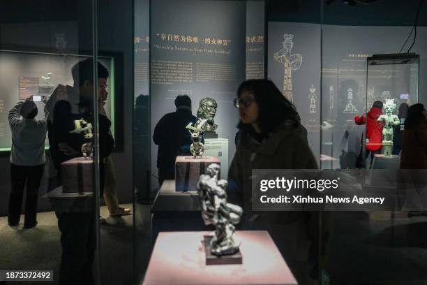 People visit an exhibition titled "Glory of Bronze Civilization" in the Museum of Shanghai University in Shanghai, east China, Dec. 22, 2023. The...