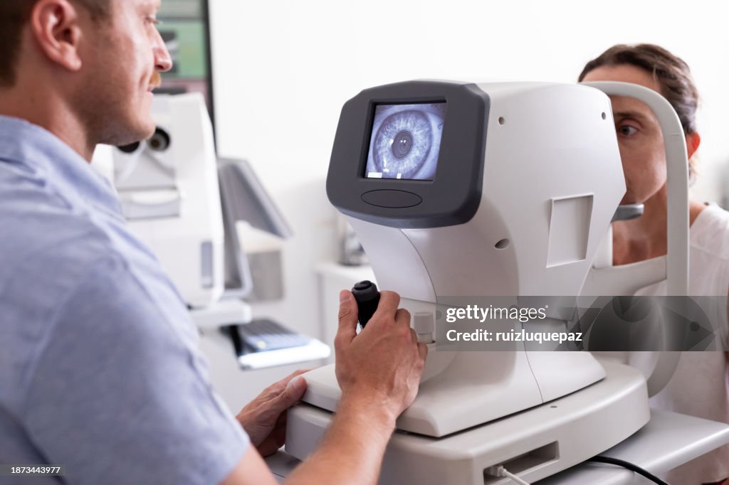 Ophthalmologist examining patient in his office