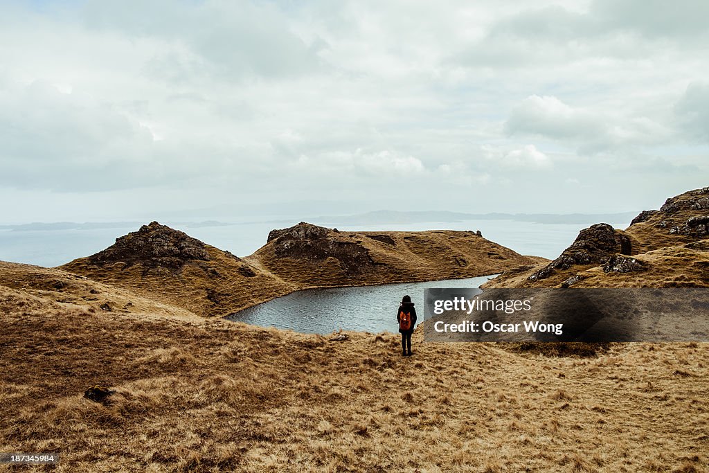 A young girl hiking alone