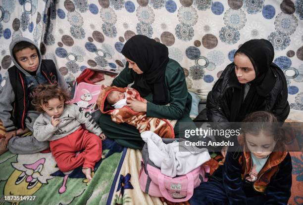 Gazan mother, Sabreen al-Azami, who was displaced from Beit Lahia city when she was 7 months pregnant due to Israeli attacks, is seen holding her...