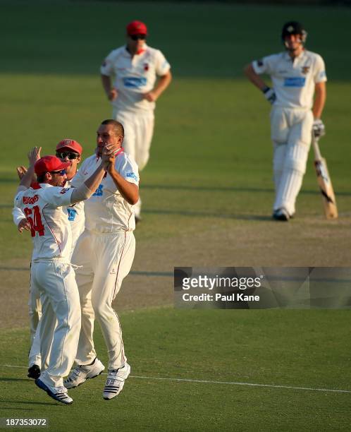 Trent Lawford of the Redbacks celebrates the wicket of Jason Behrendorff of the Warriors during day three of the Sheffield Shield match between the...