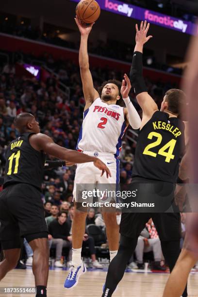 Cade Cunningham of the Detroit Pistons gets a first half shot off over Walker Kessler of the Utah Jazz at Little Caesars Arena on December 21, 2023...