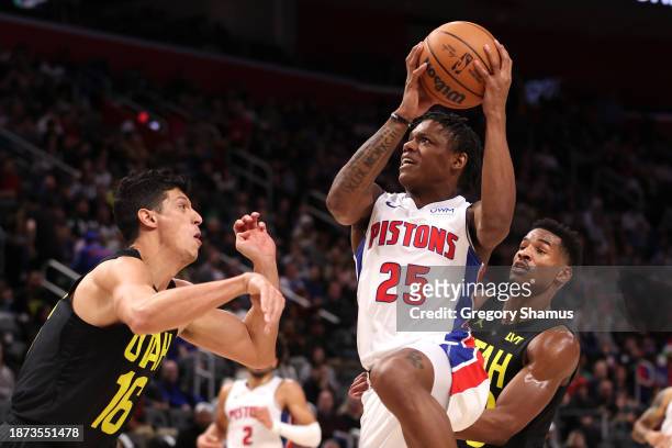 Marcus Sasser of the Detroit Pistons tries to get a first half shot off around Simone Fontecchio of the Utah Jazz at Little Caesars Arena on December...